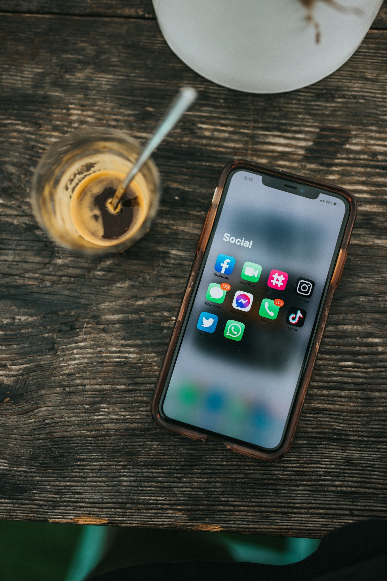 Smartphone with social apps beside a coffee – social media & UGC agency in Delhi NCR