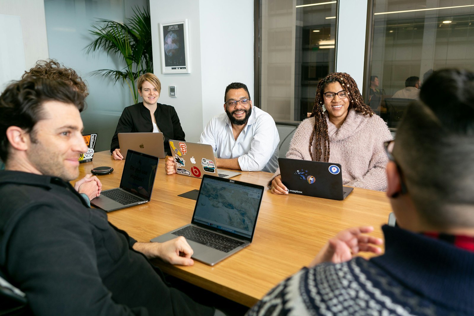 Team discussing brand growth on laptops – brand consulting in Delhi NCR