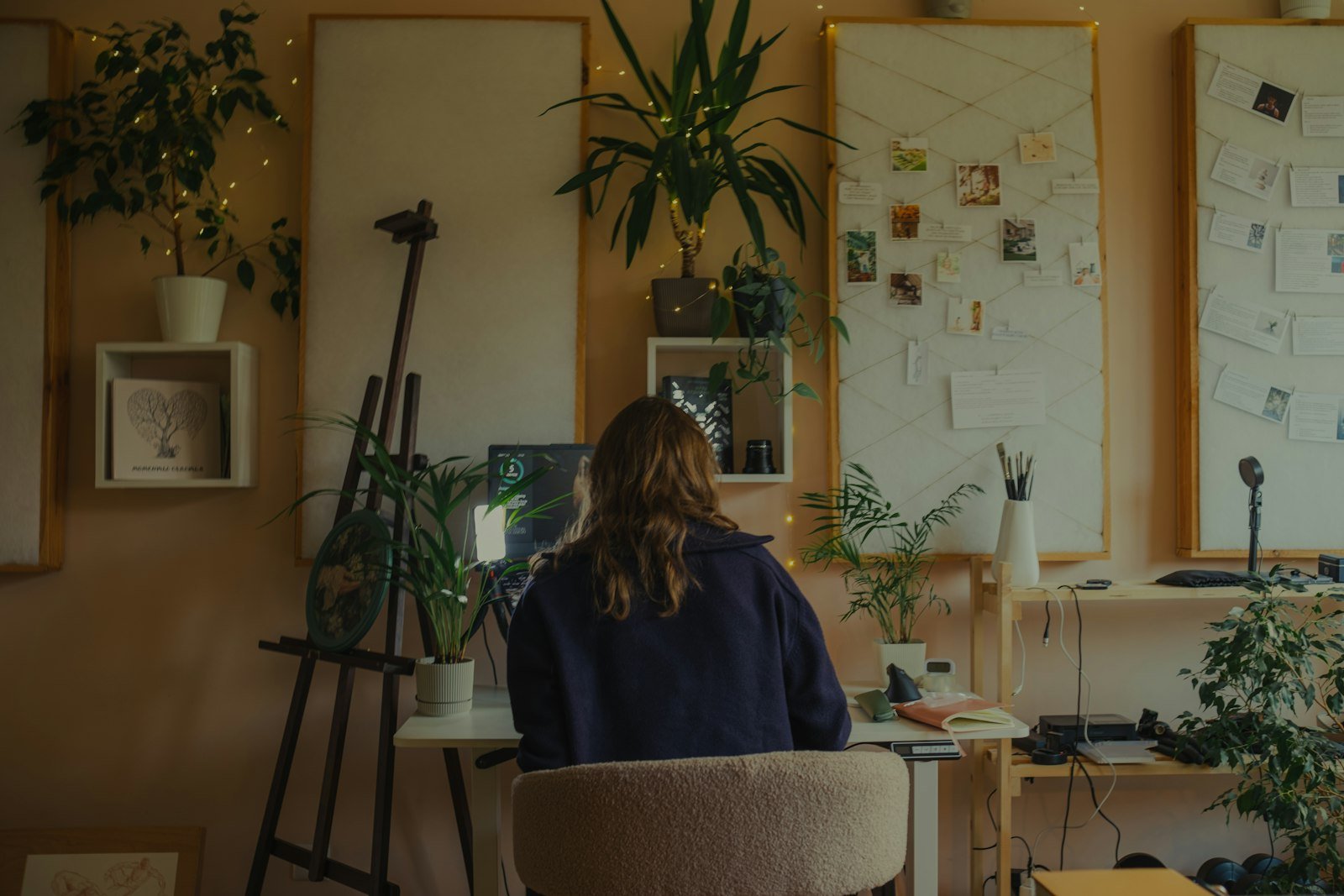Designer working in a plant-filled studio – Ss Infoserve, creative agency in Delhi